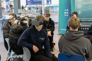 Students in a college atrium taking part in a VR session