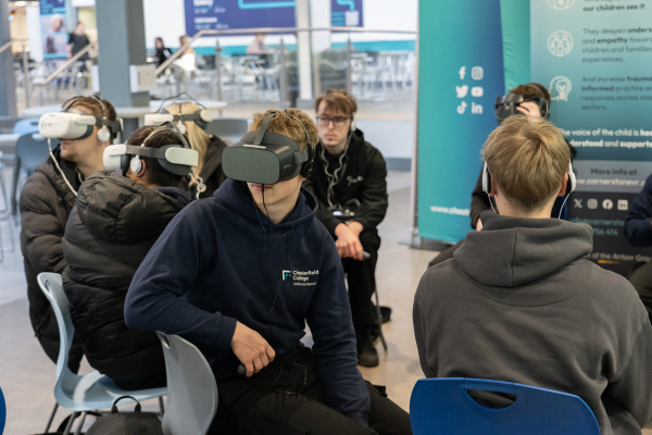 Students in a college atrium taking part in a VR session